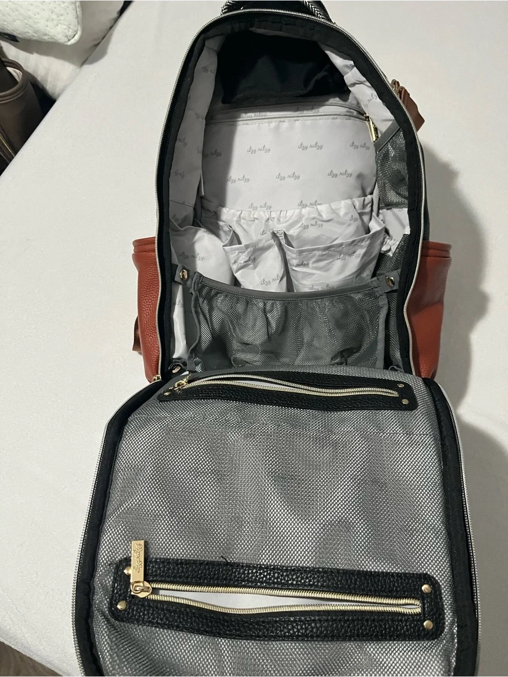 Itzy Ritzy Baby Diaper Bag Backpack in Black, White, brown with wipes case
